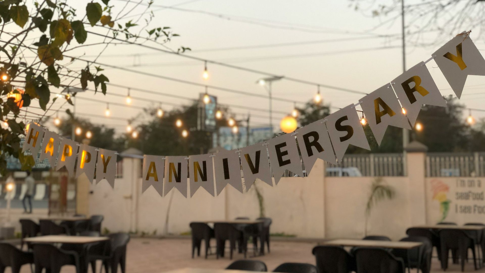 a party banner hanging over a table in a restaurant