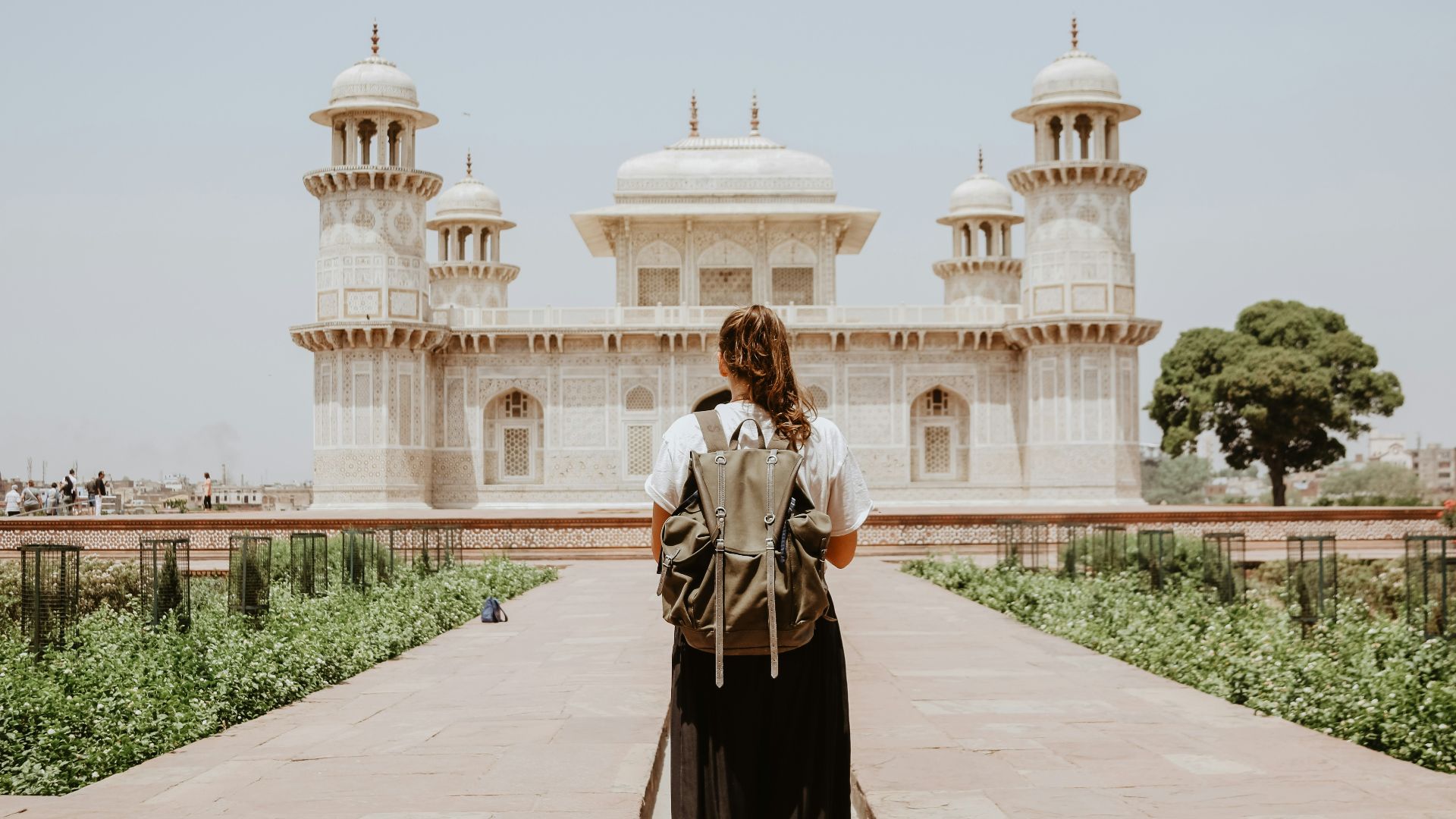 woman near beige painted building