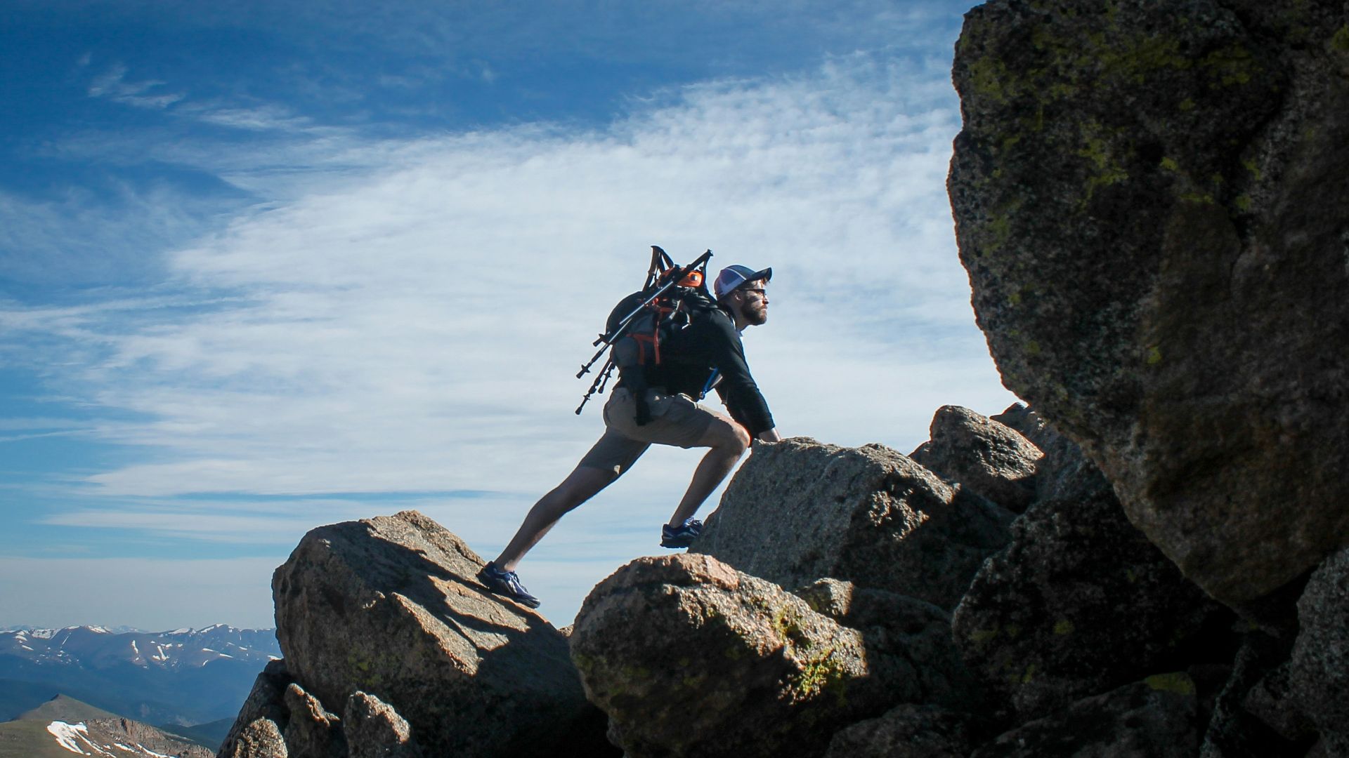 photo of man climbing mountain
