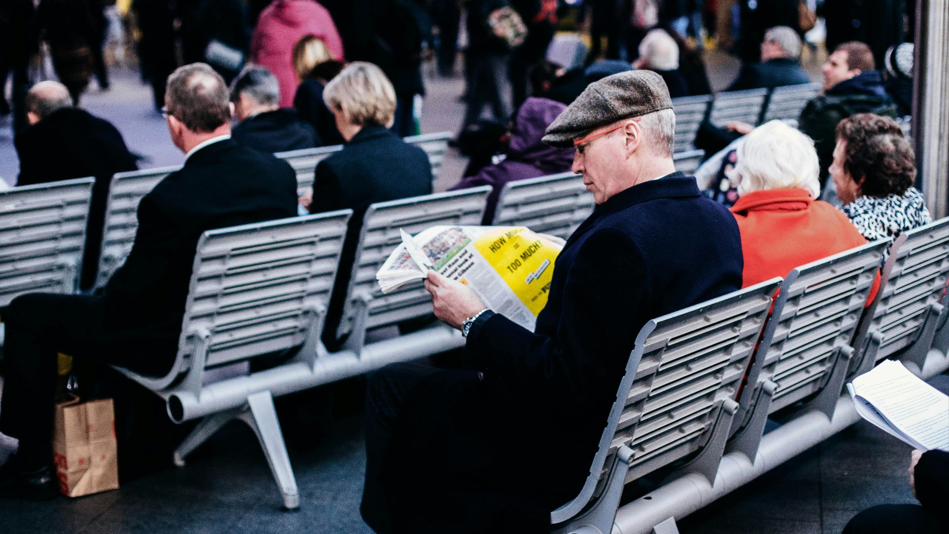 people reading on grey gang chairs