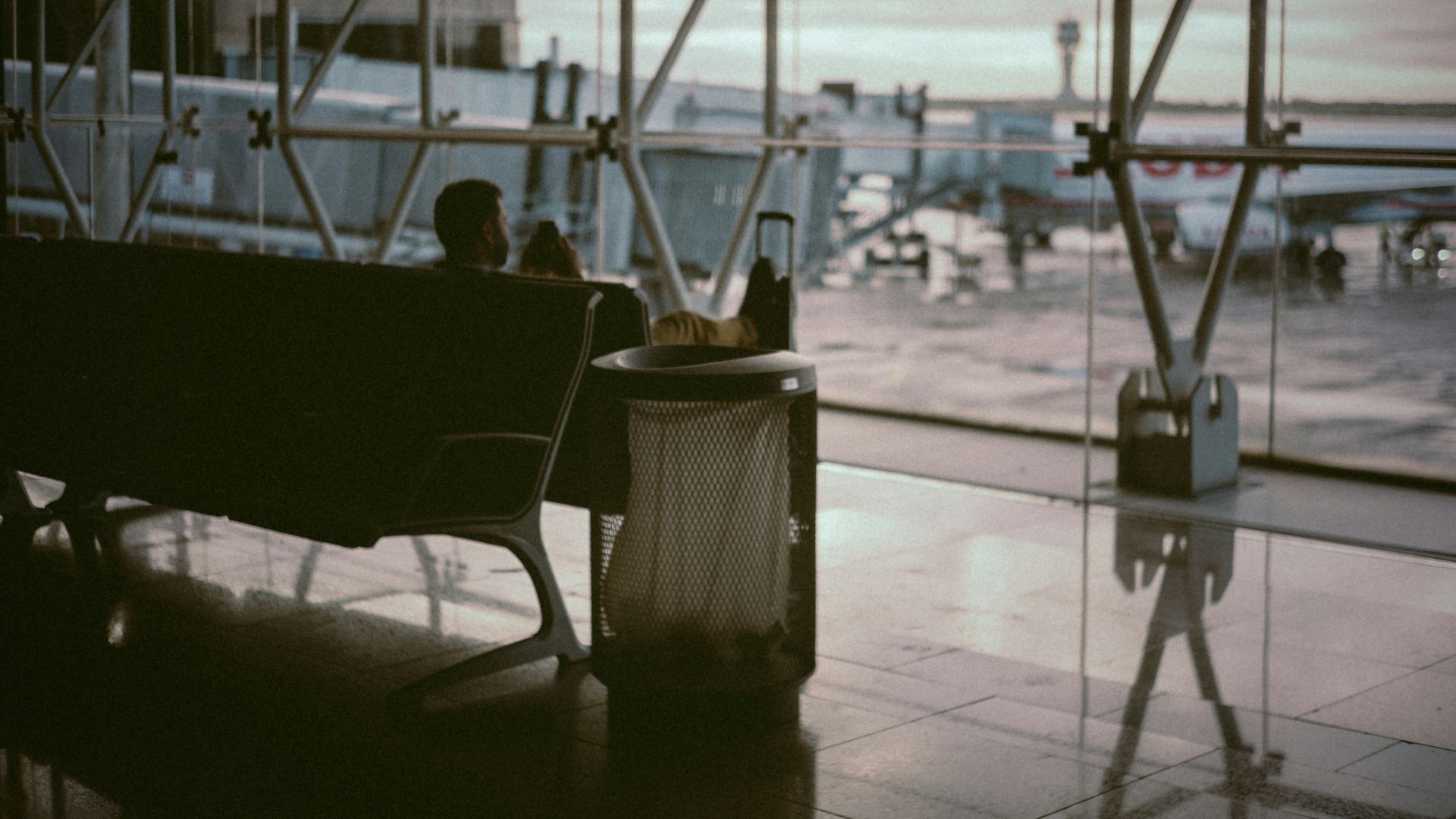 man sitting inside airport's boarding area