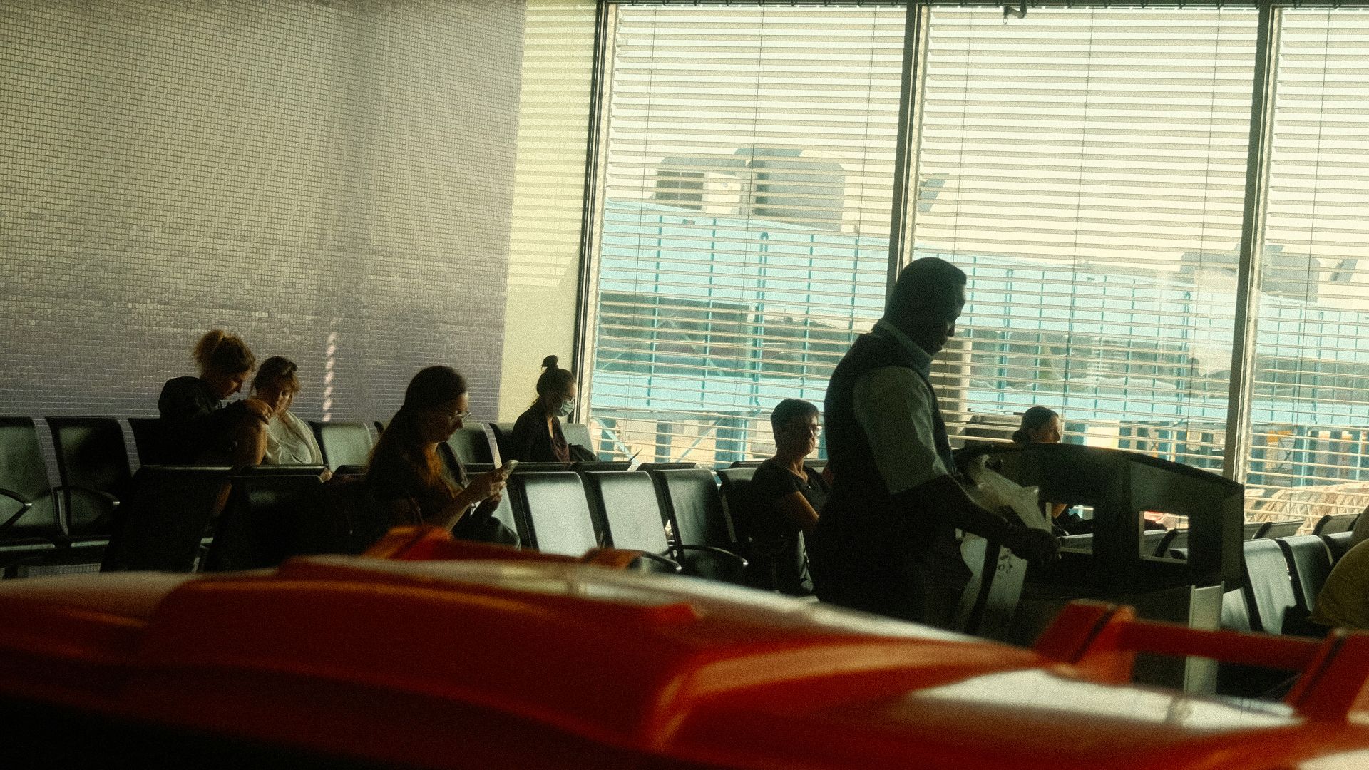 a group of people sitting at a table in an airport