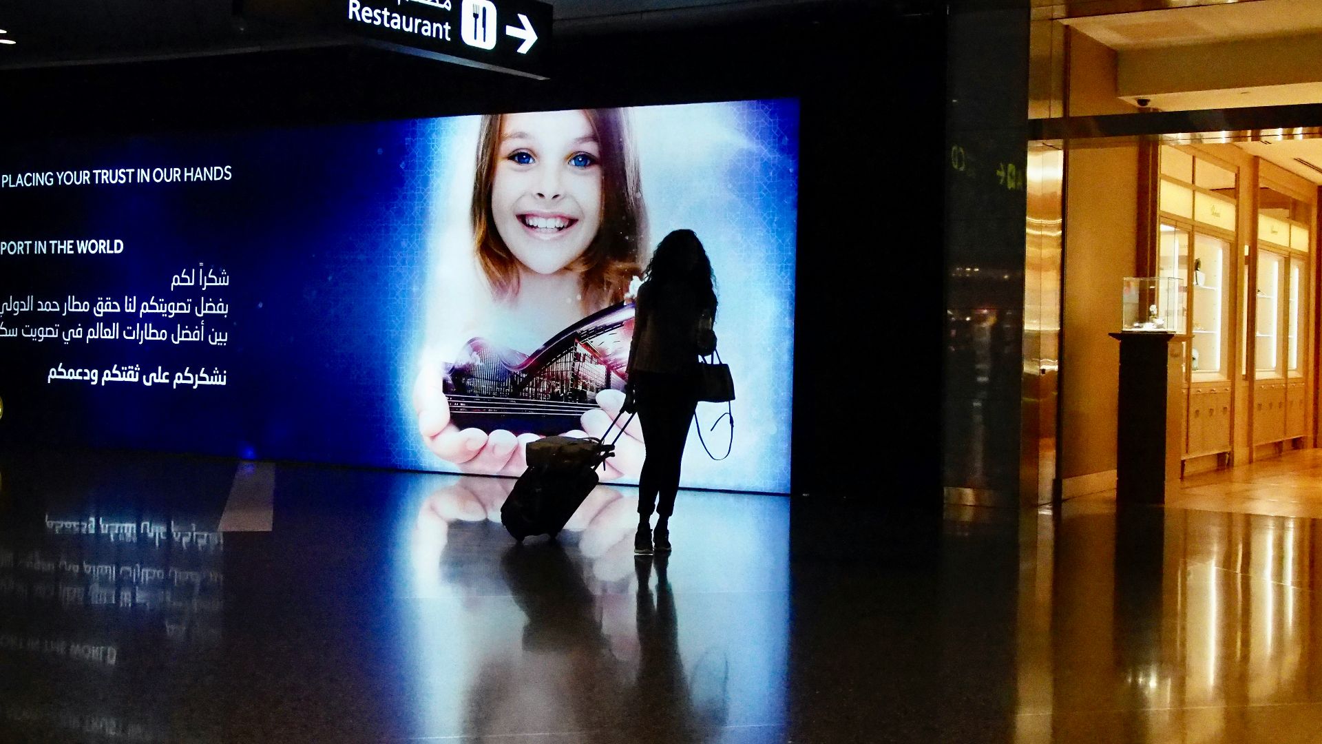 woman in black long sleeve shirt and black pants holding black and white electric guitar