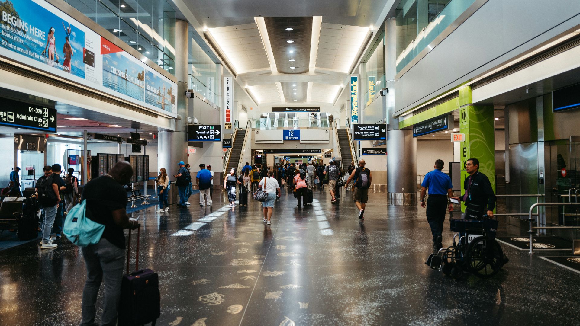 a group of people walking through an airport