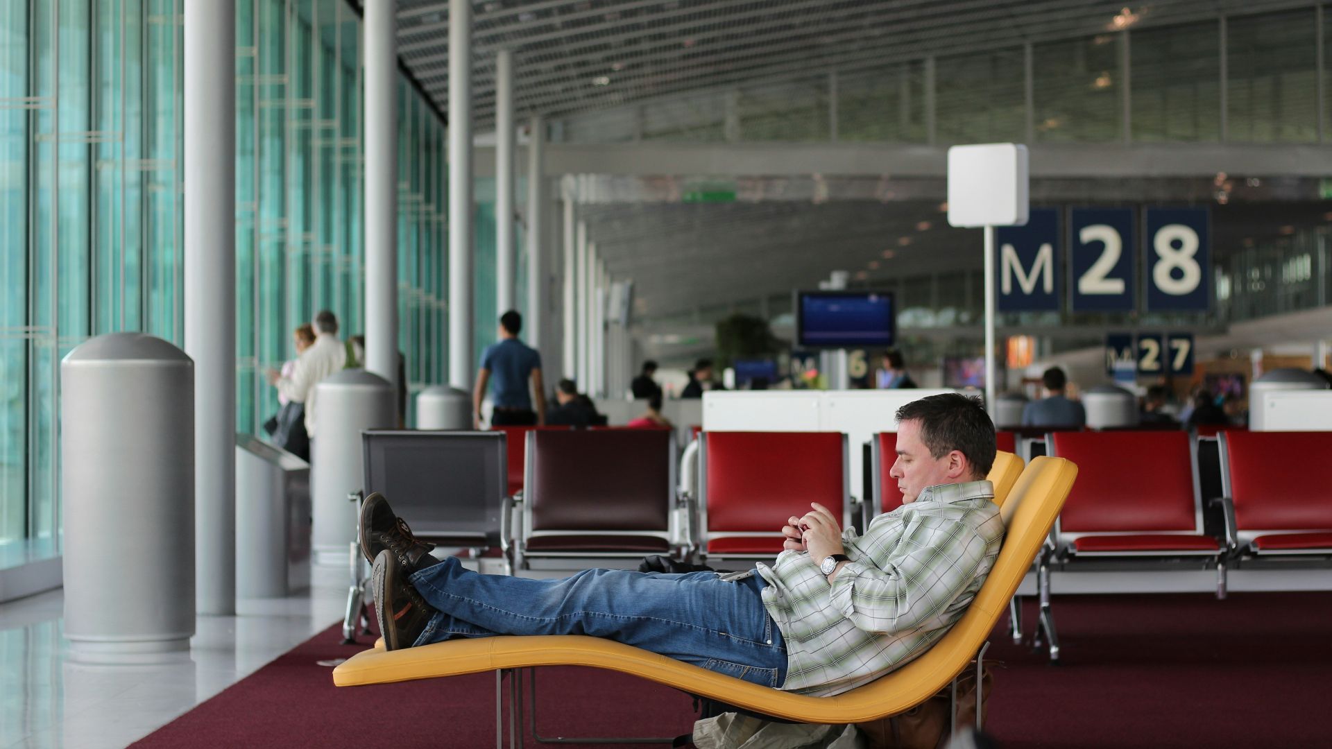 man sitting on airport waiting area