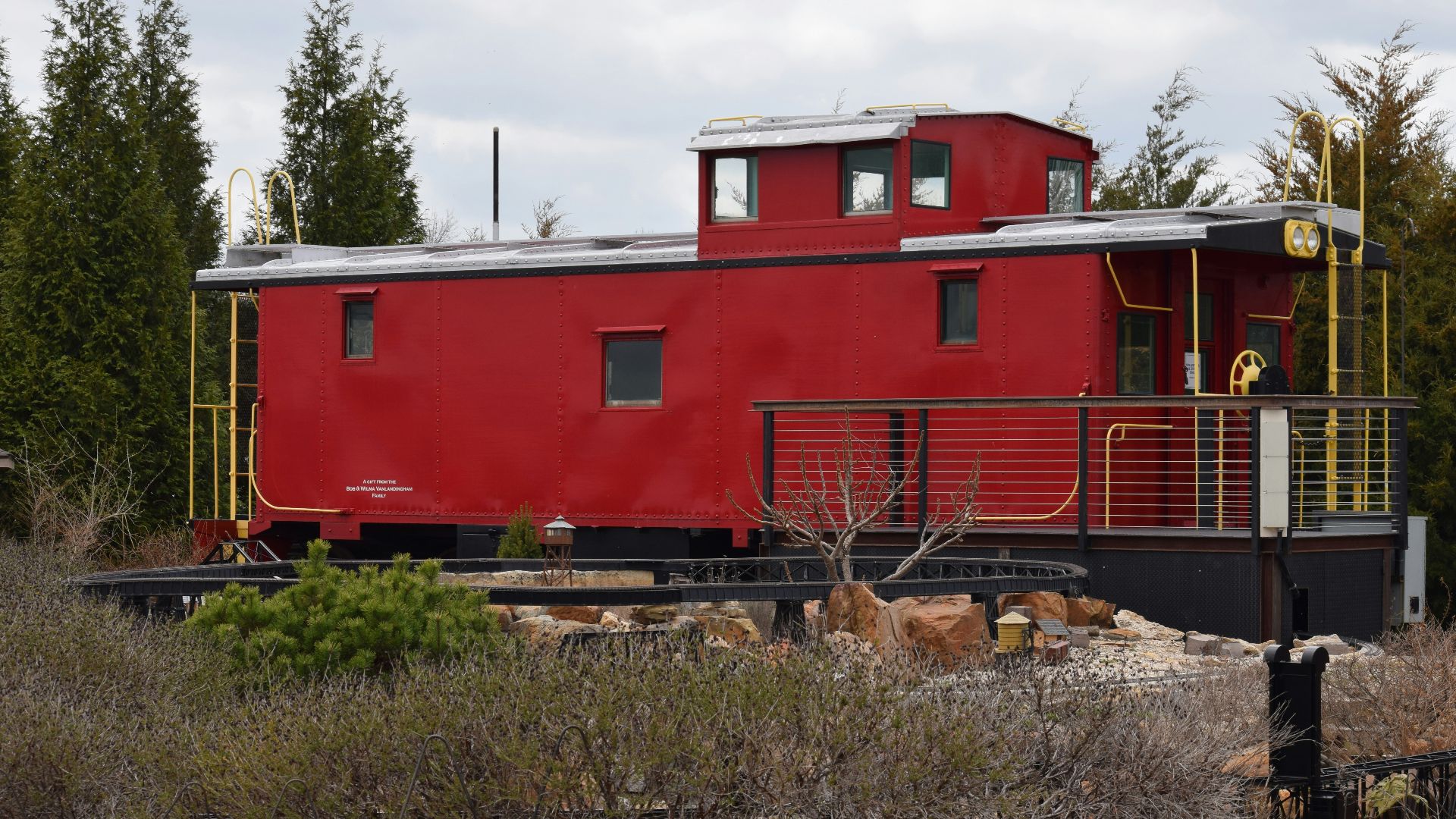 a red train car sitting on top of a train track