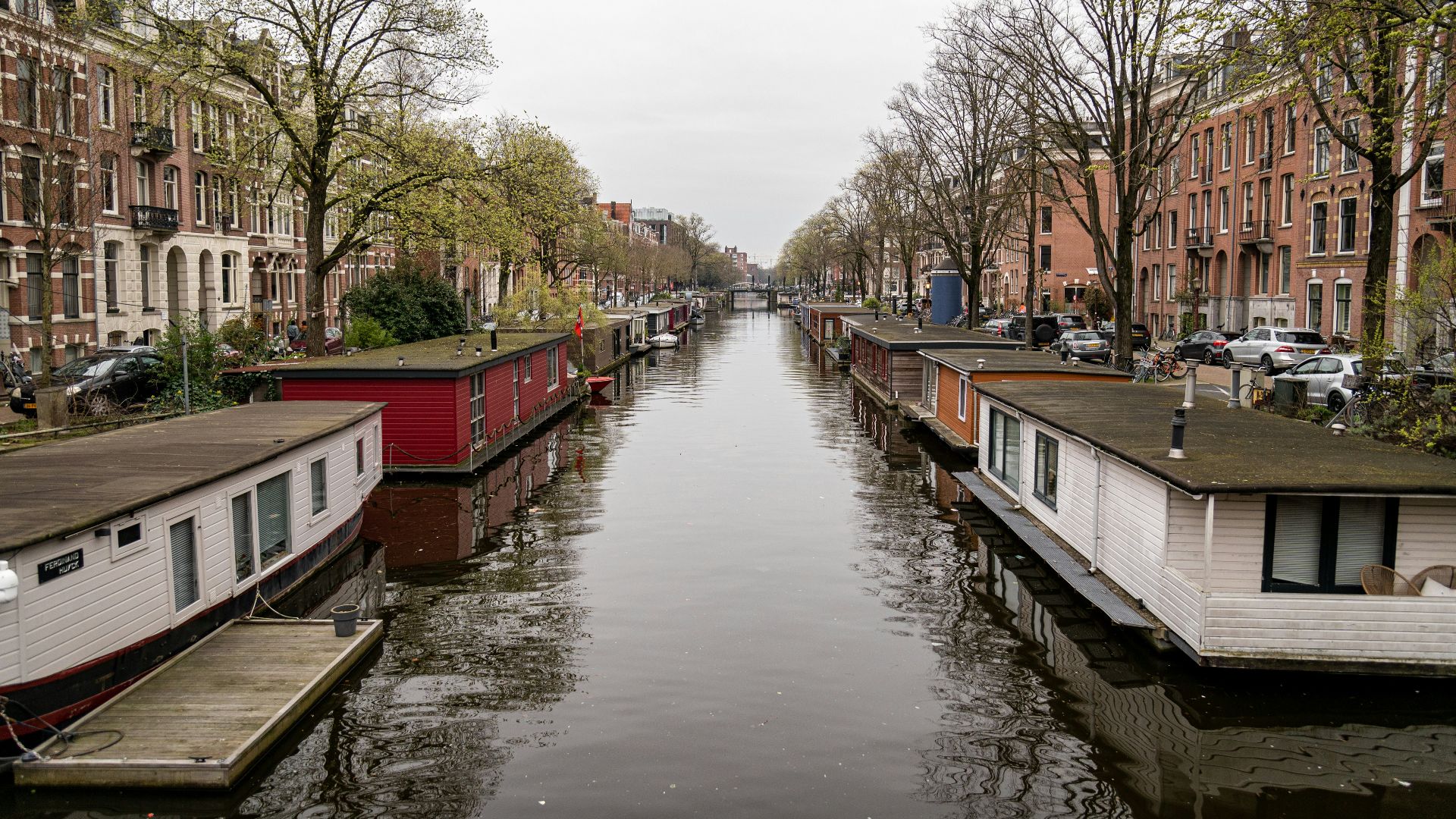 a narrow canal with houses on both sides