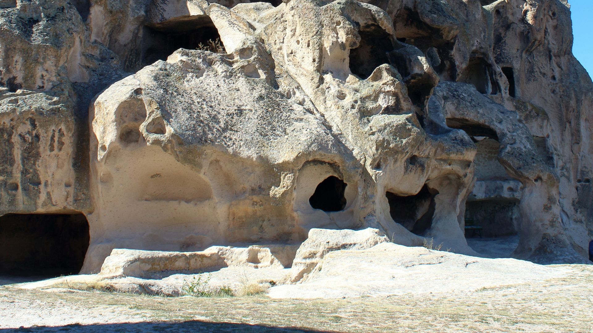 a rocky outcropping with a cave in the middle