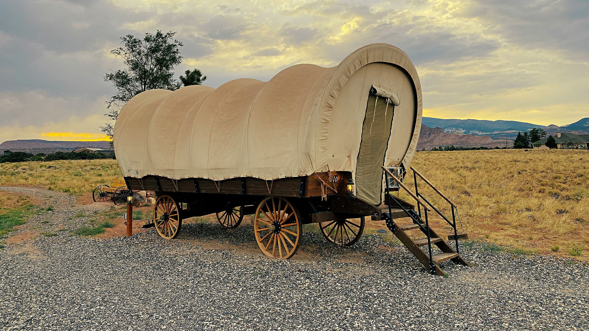 brown wooden carriage on gray sand during daytime