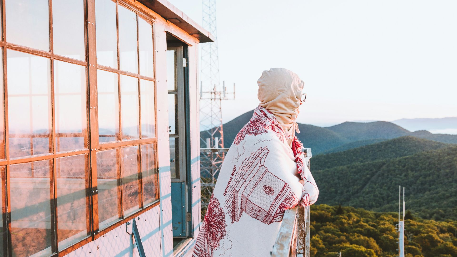 woman in white hijab standing near brown wooden fence during daytime