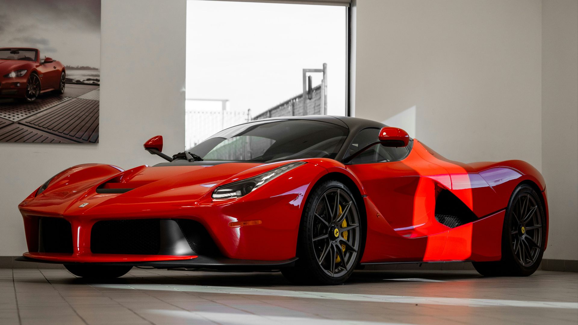 red ferrari 458 italia parked in front of white wall