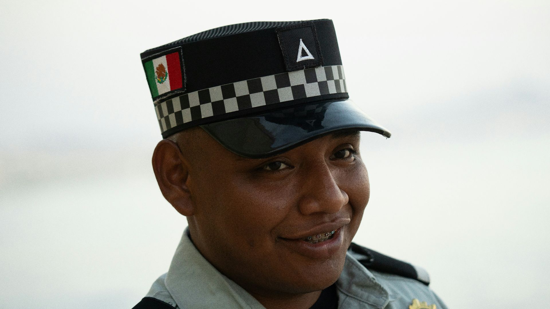 A smiling mexican official is posed for a picture.