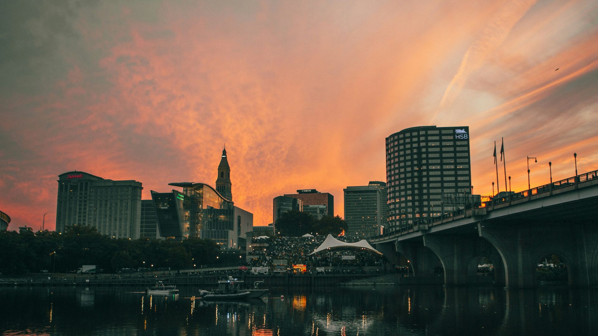 a city skyline with a bridge over a river