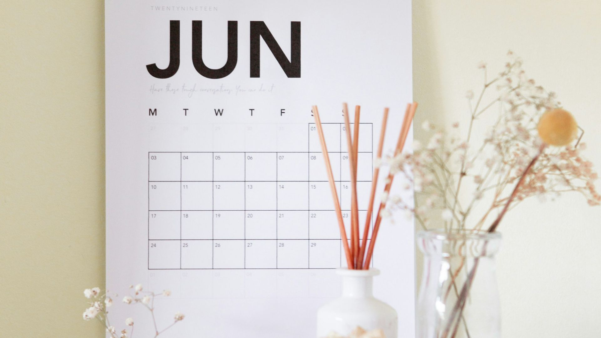 vase on book near calendar