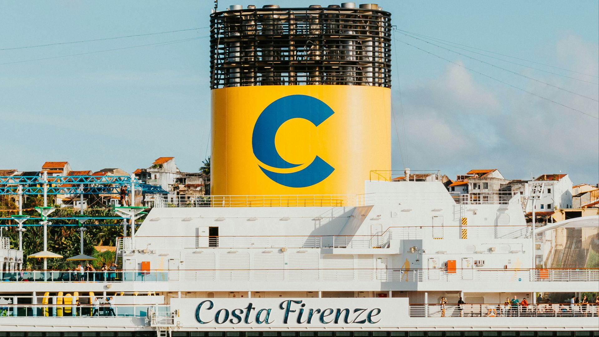 a large cruise ship with a large water tower in the background