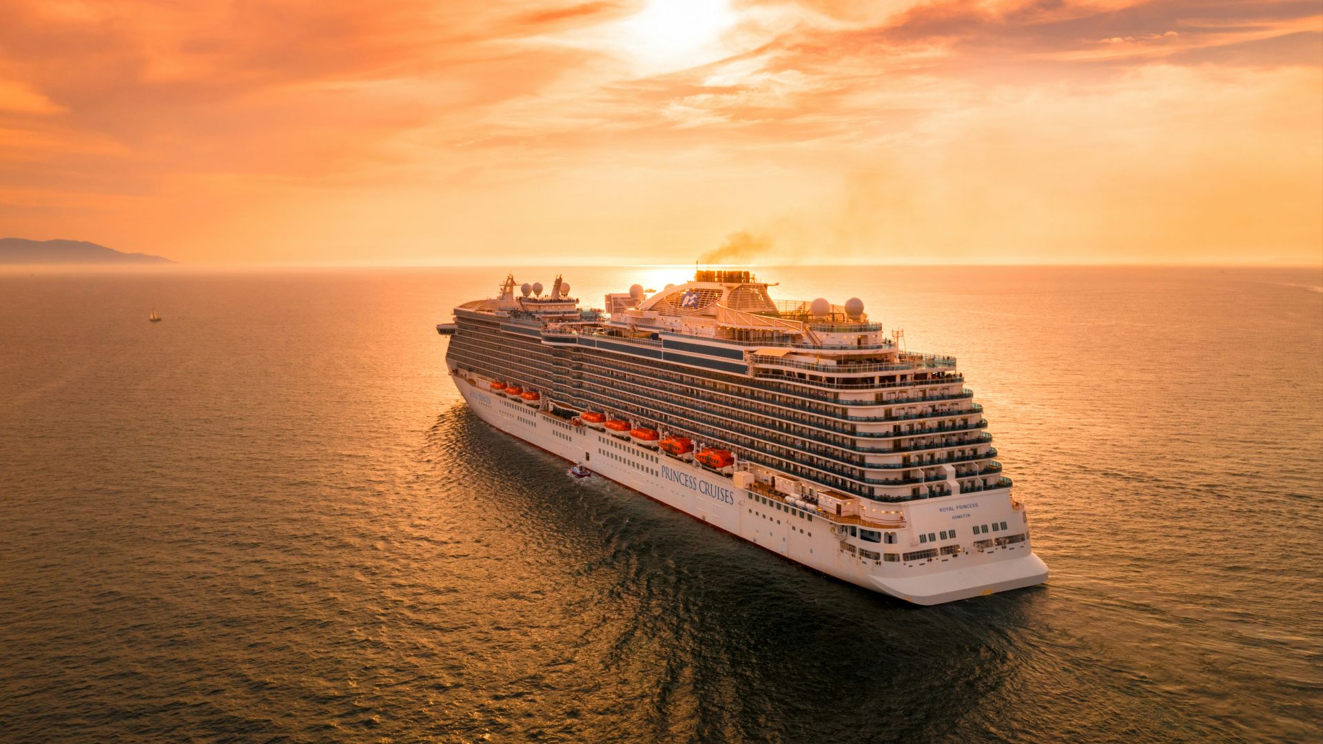 white ship on sea during sunset