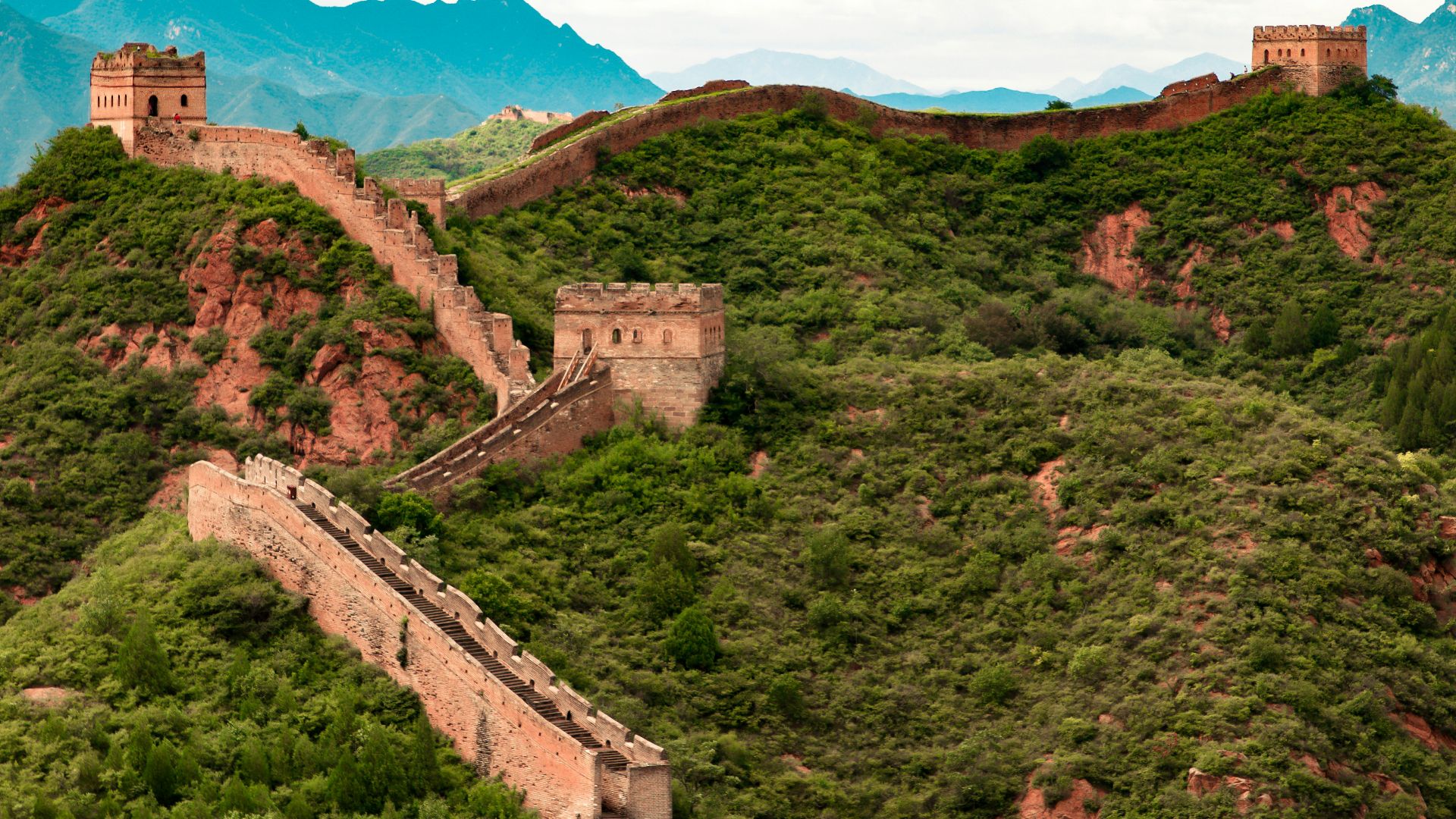 green trees on mountain under white clouds during daytime