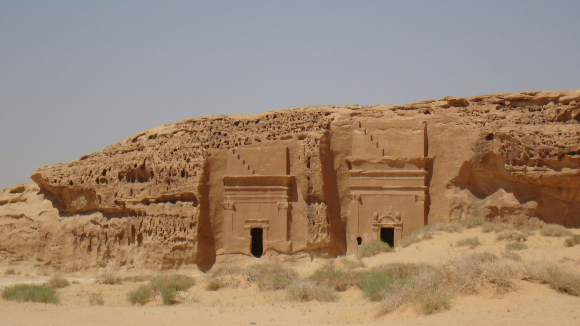 a desert scene with a building in the middle of the desert