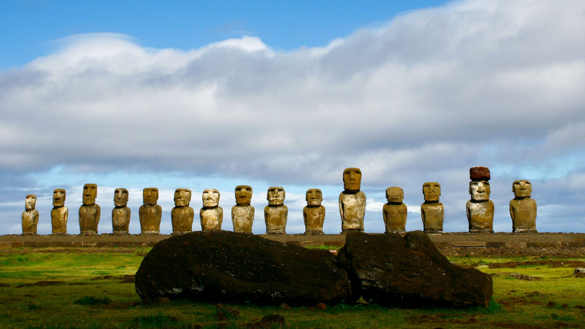 gray rock formation under white clouds and blue sky during daytime
