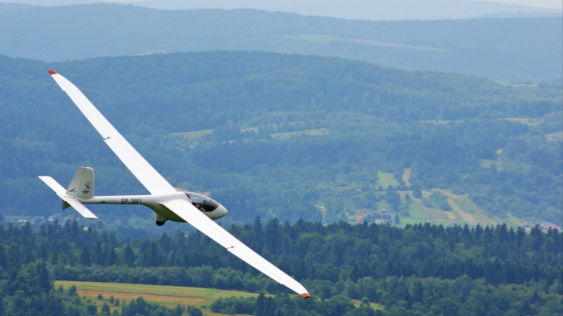 white plane flying mid-air during daytime