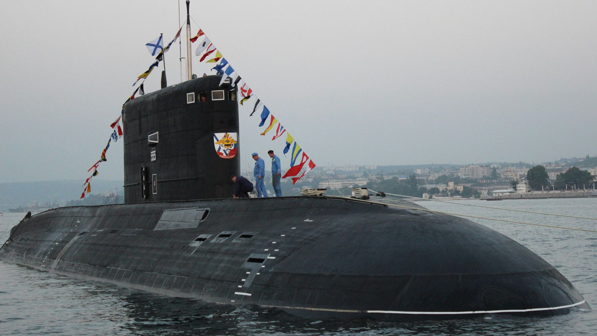 black ship on sea under gray sky during daytime