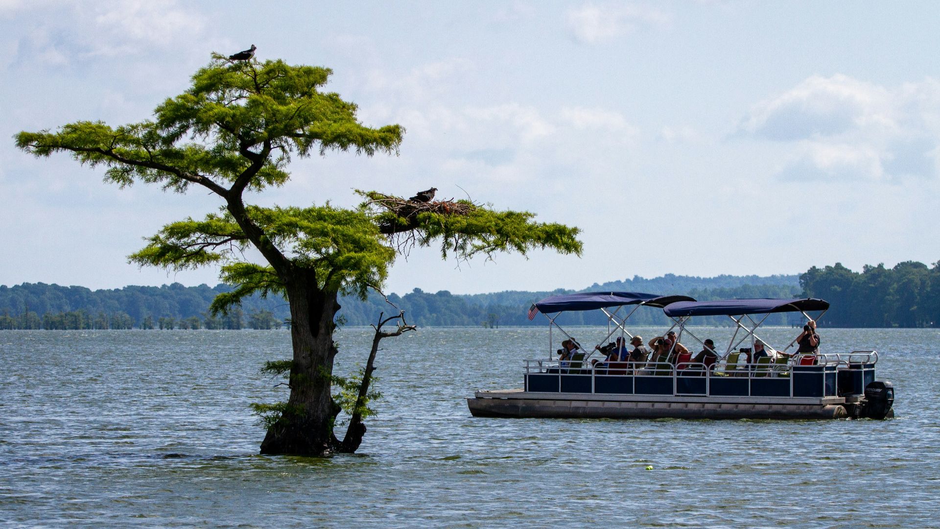 a boat full of people on a large body of water