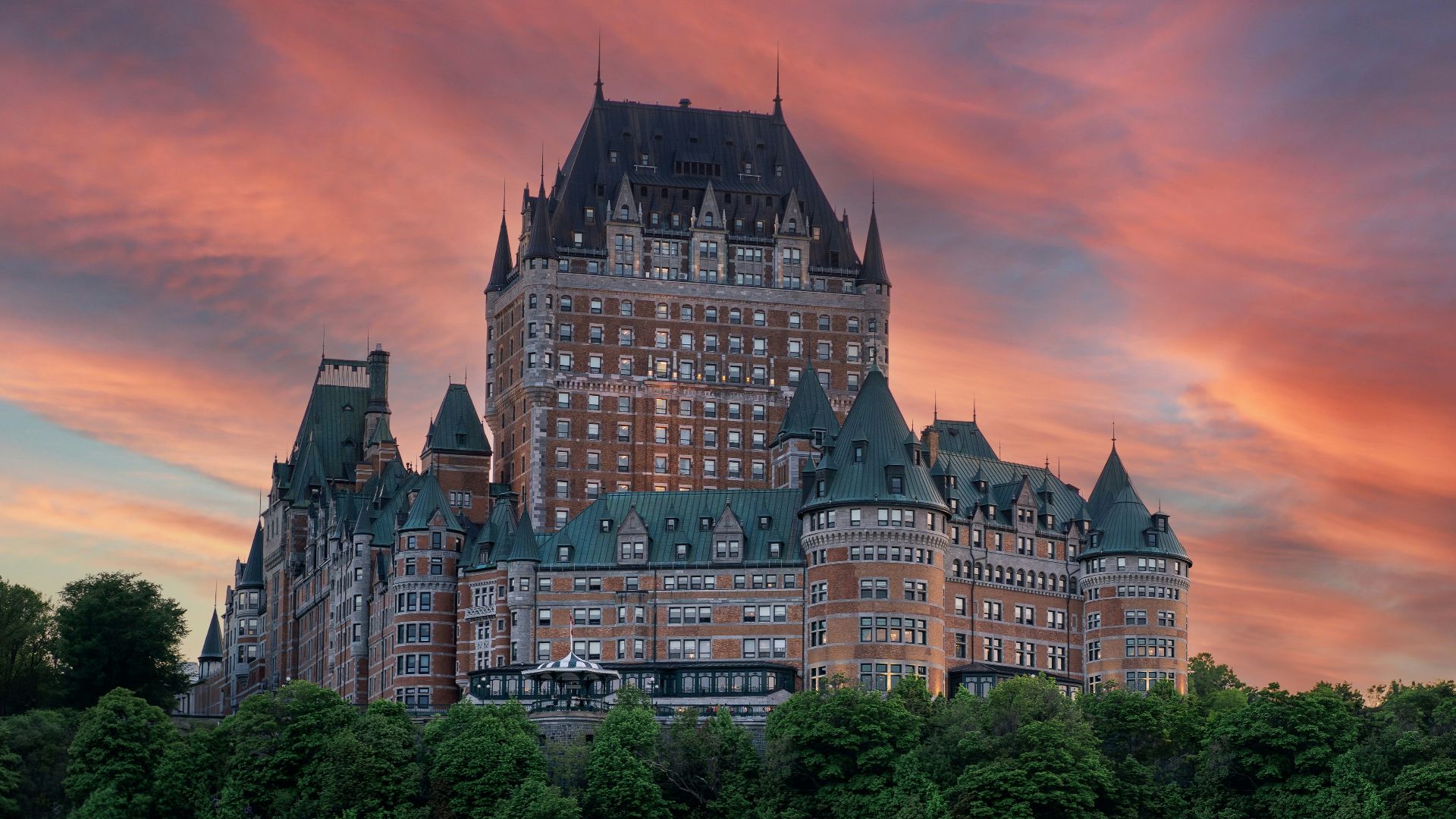 a large building with a tower on top of a hill