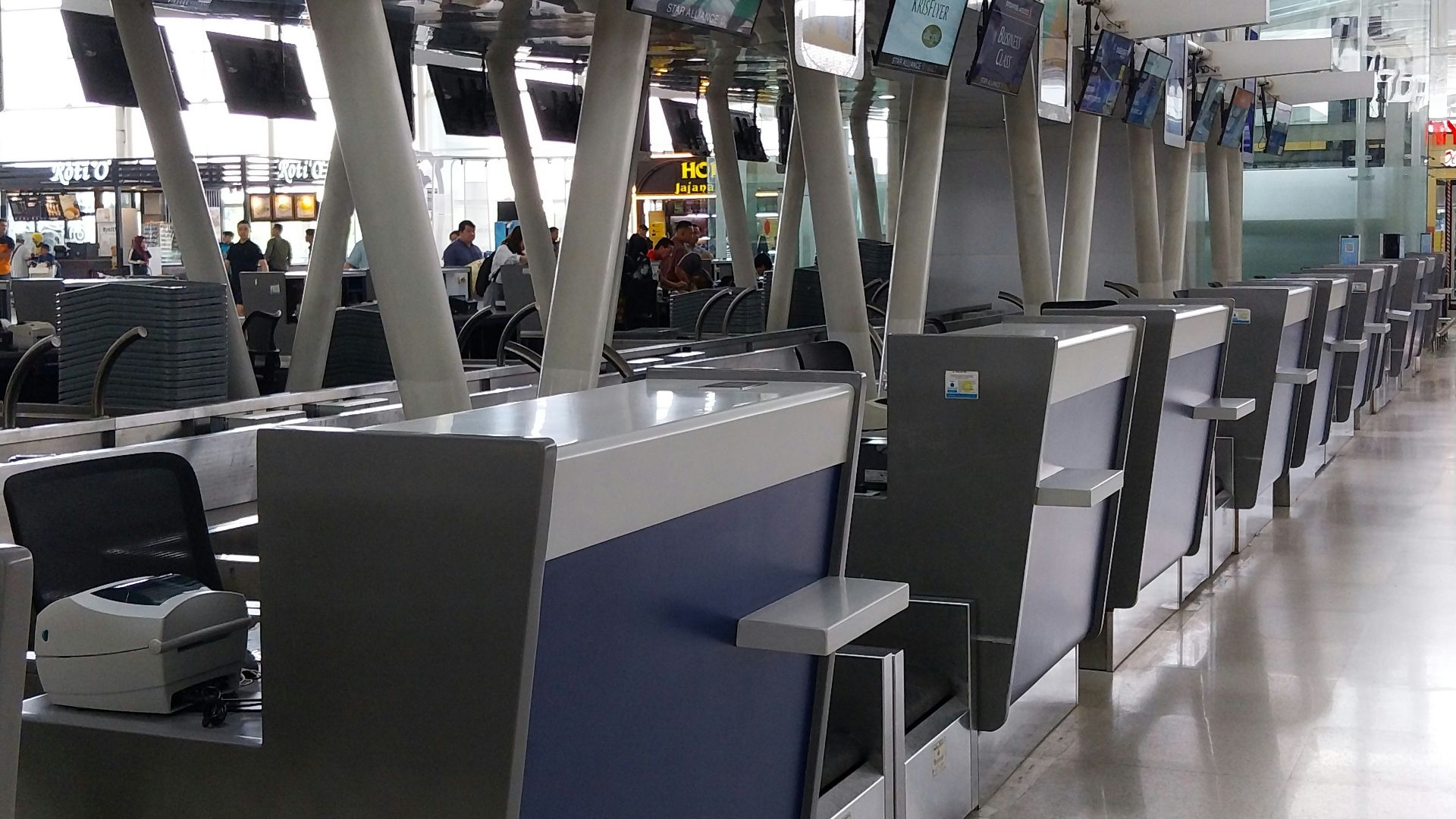 A long line of luggage carts in an airport