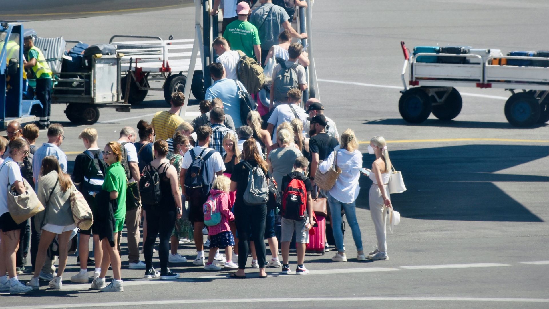 a group of people standing outside of an airplane