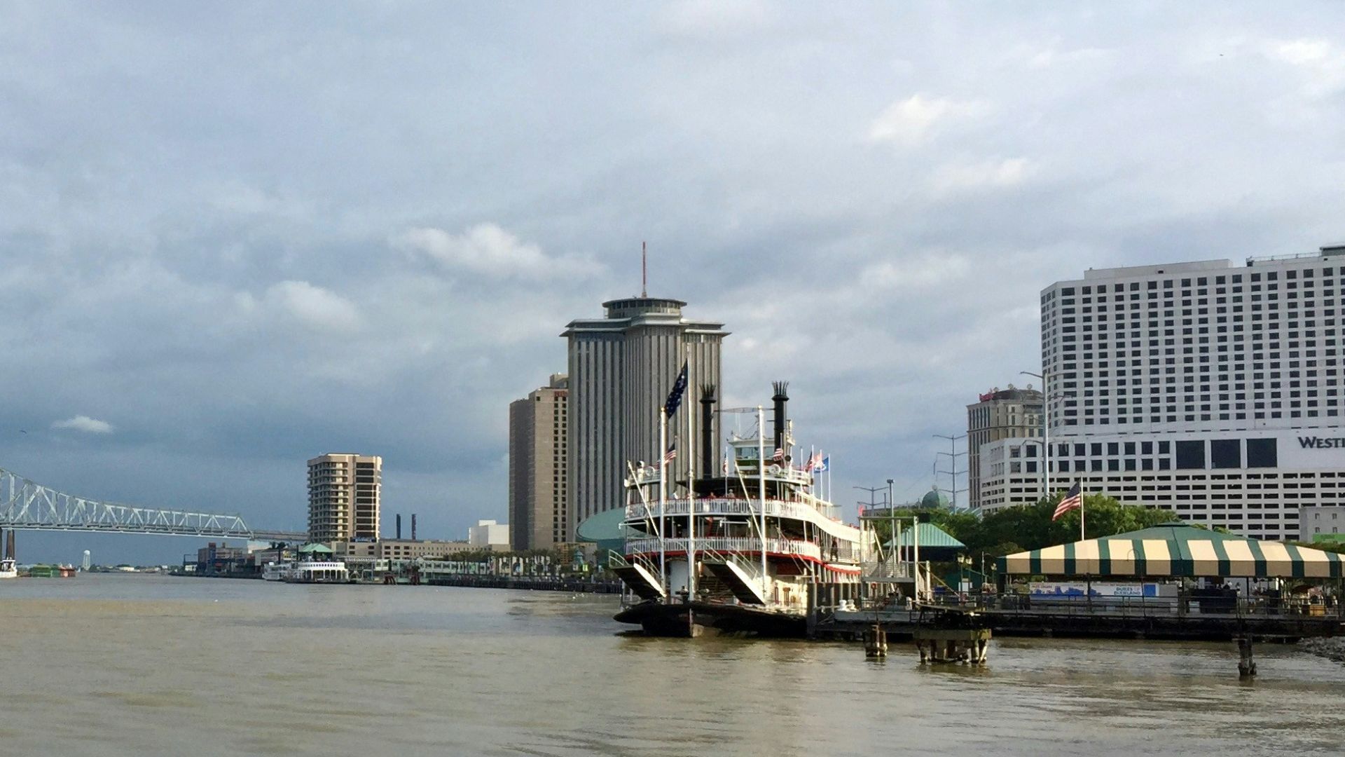 city skyline across body of water under cloudy sky during daytime