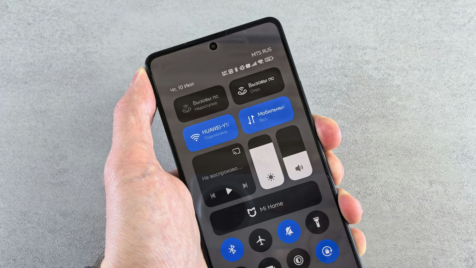 Hand holding smartphone displaying dark mode interface
