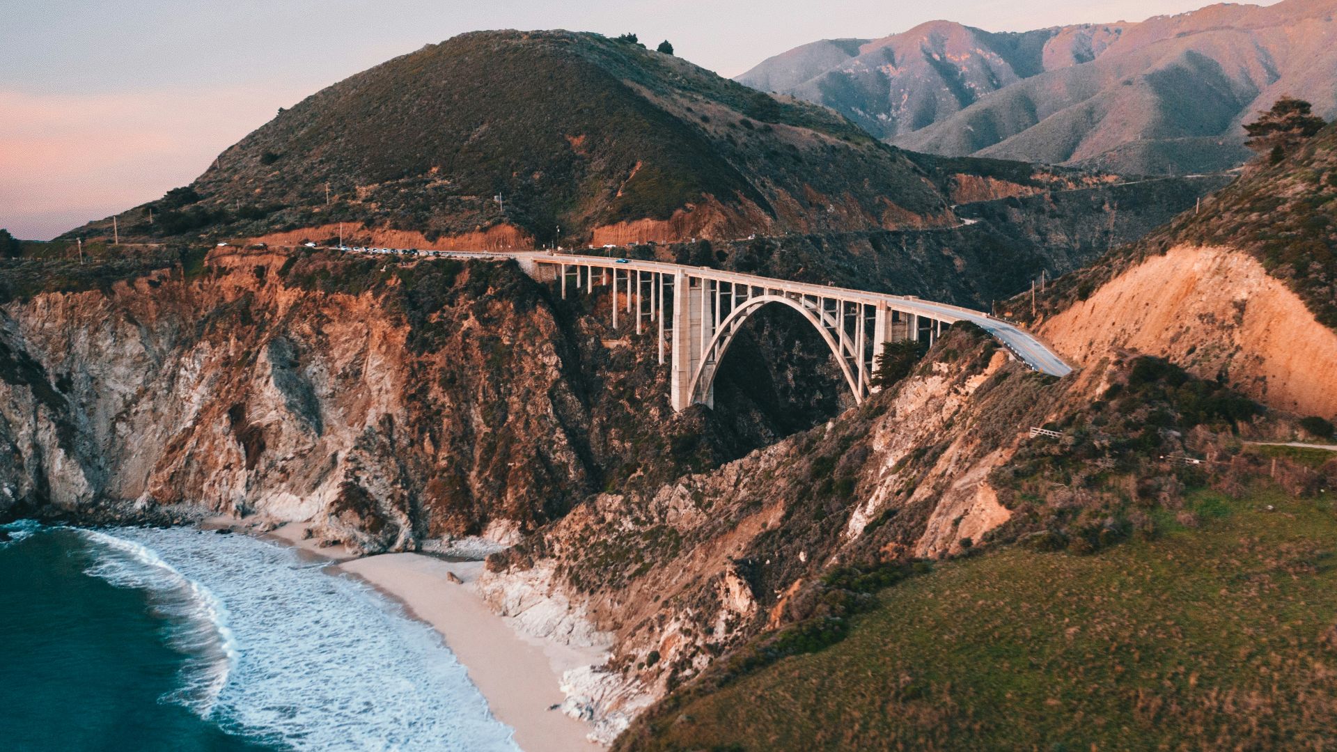 white bridge over the sea during daytime