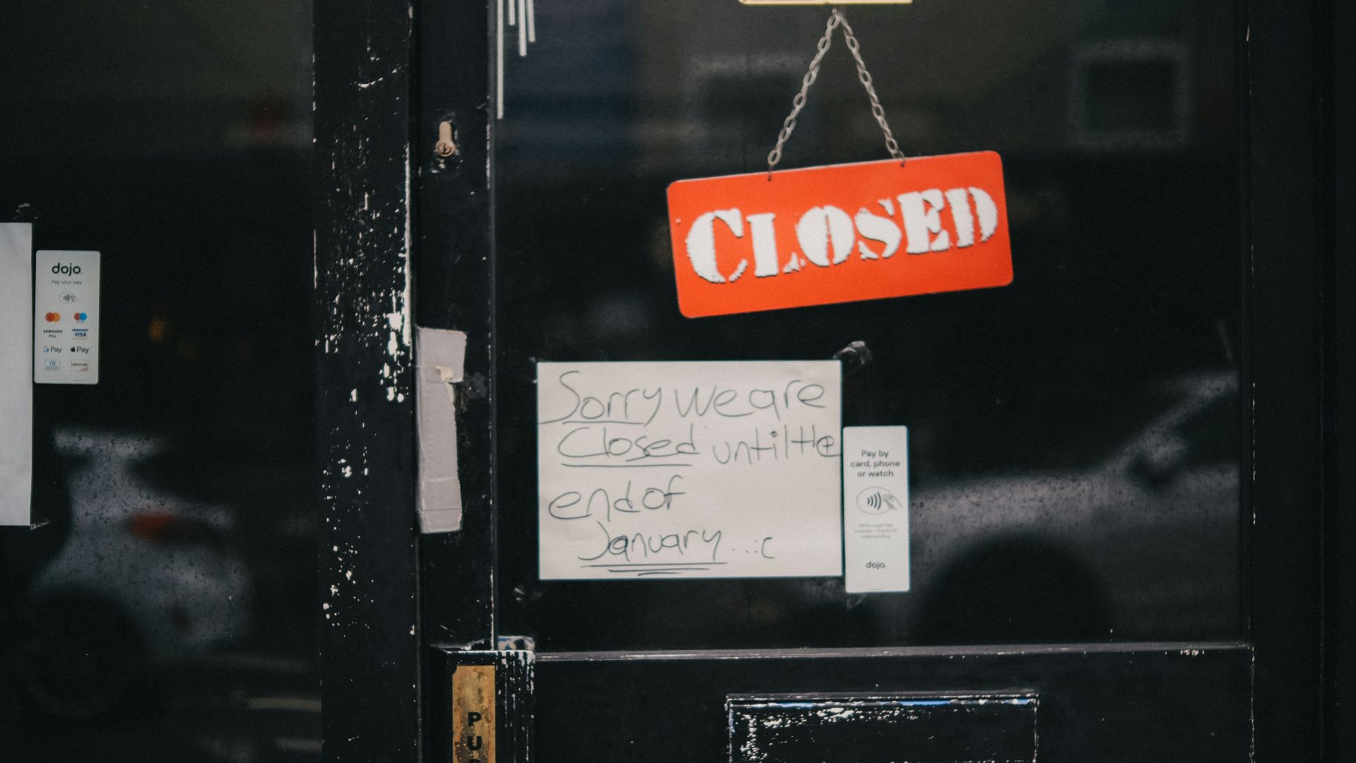 a closed door with a closed sign attached to it