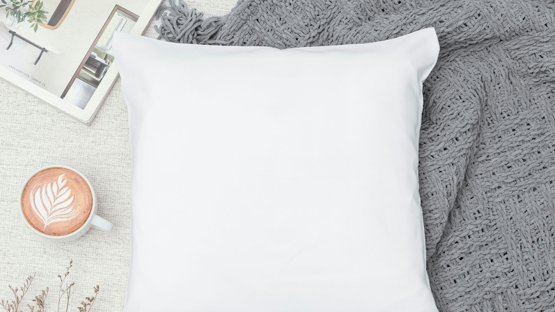 white throw pillow on white textile