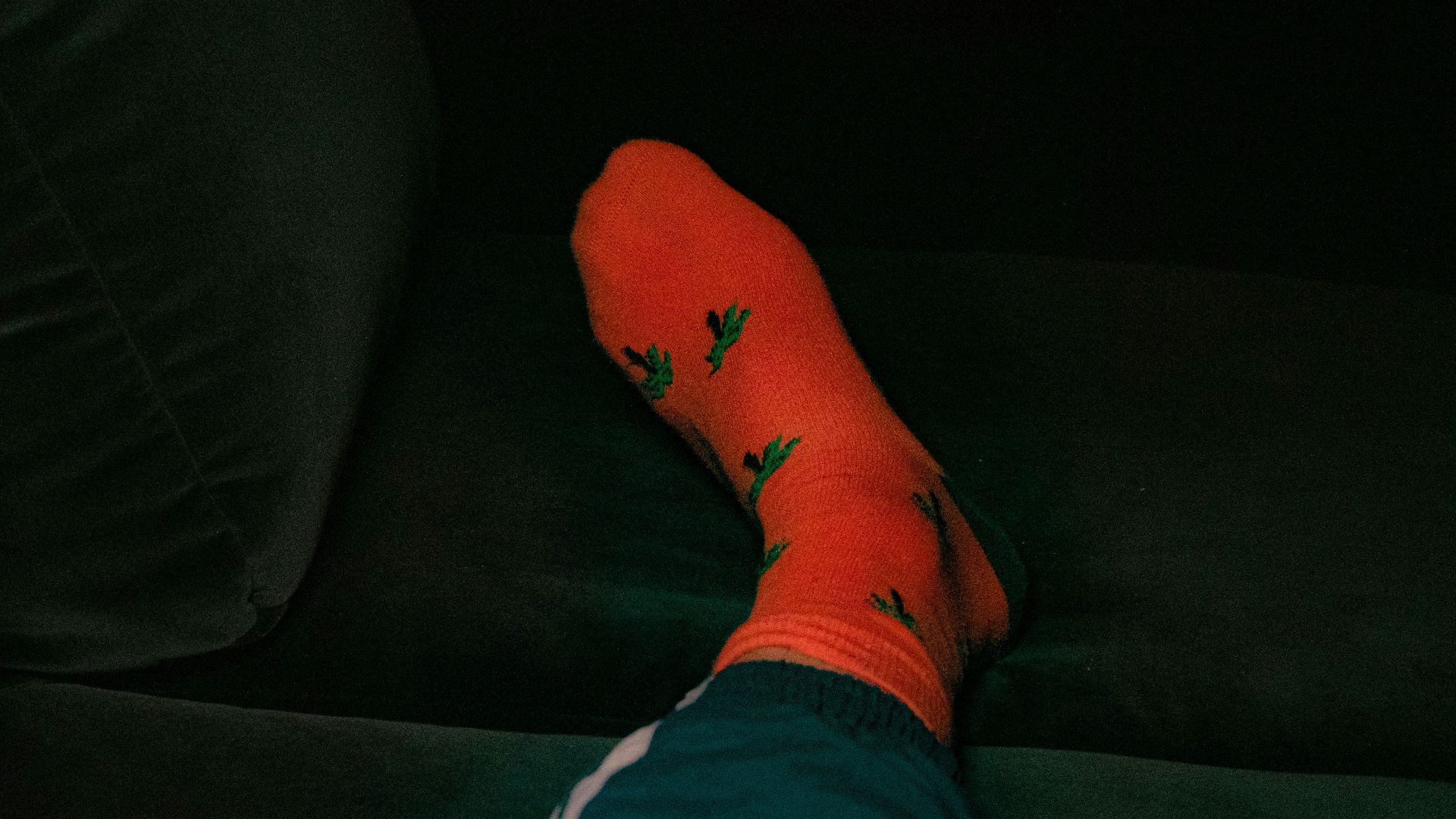 person wearing orange and green sock