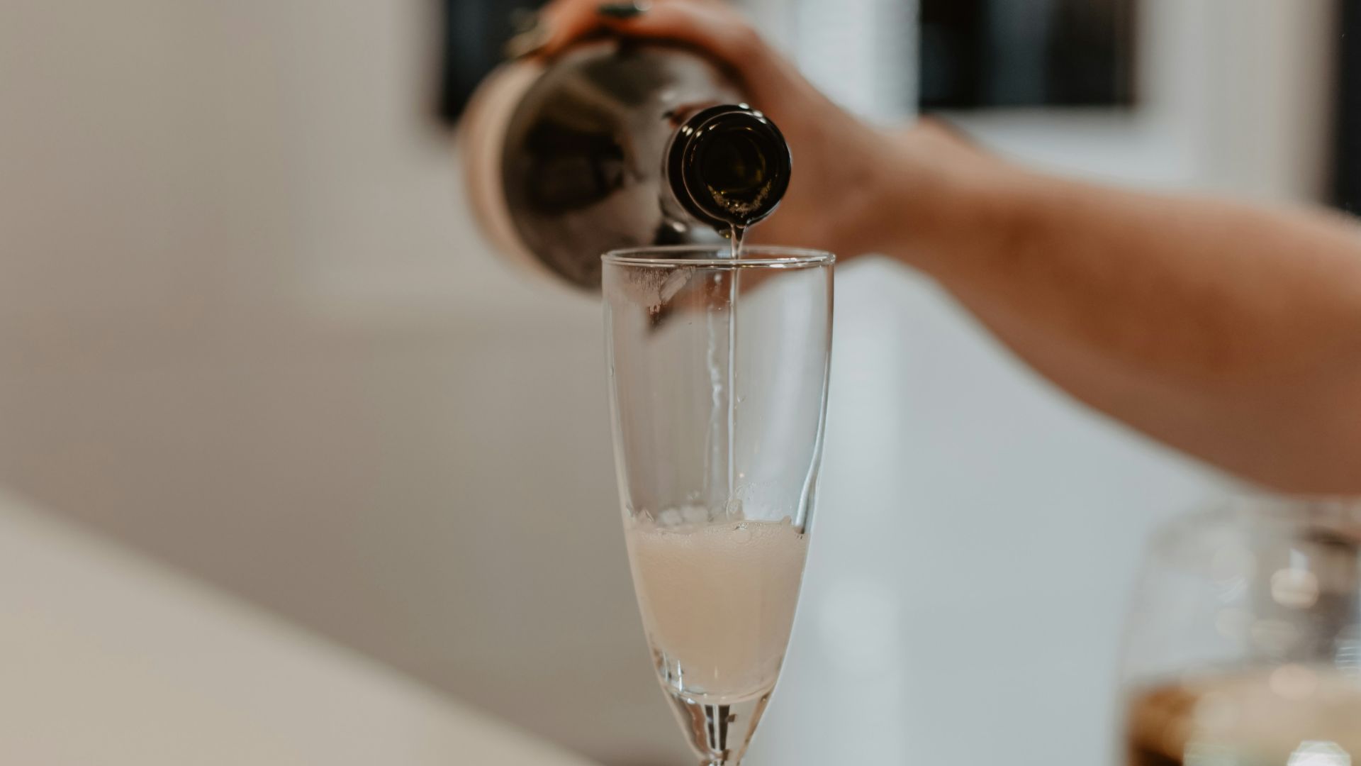 a person taking a picture of a wine glass