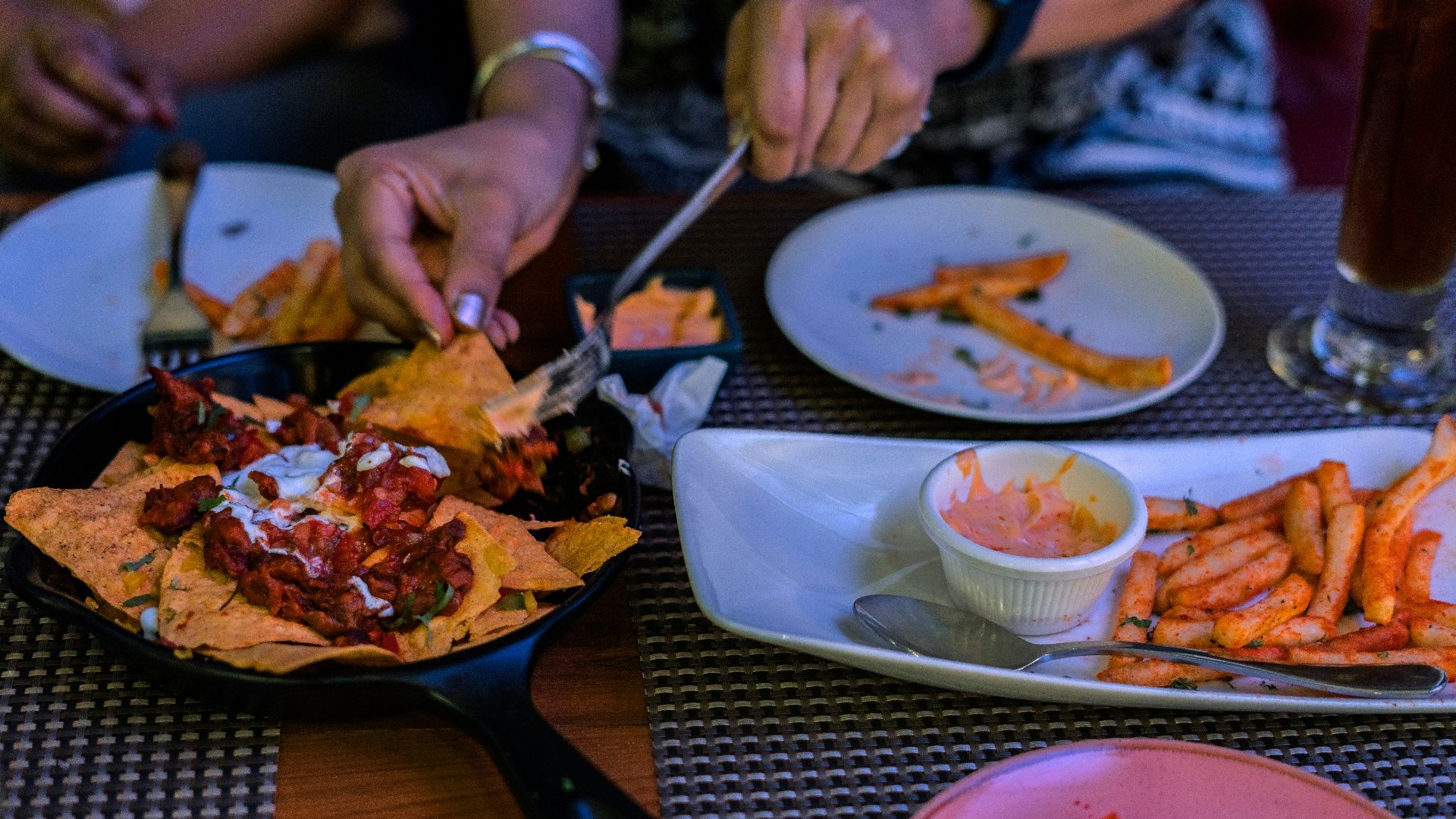 a person cutting up food on a plate