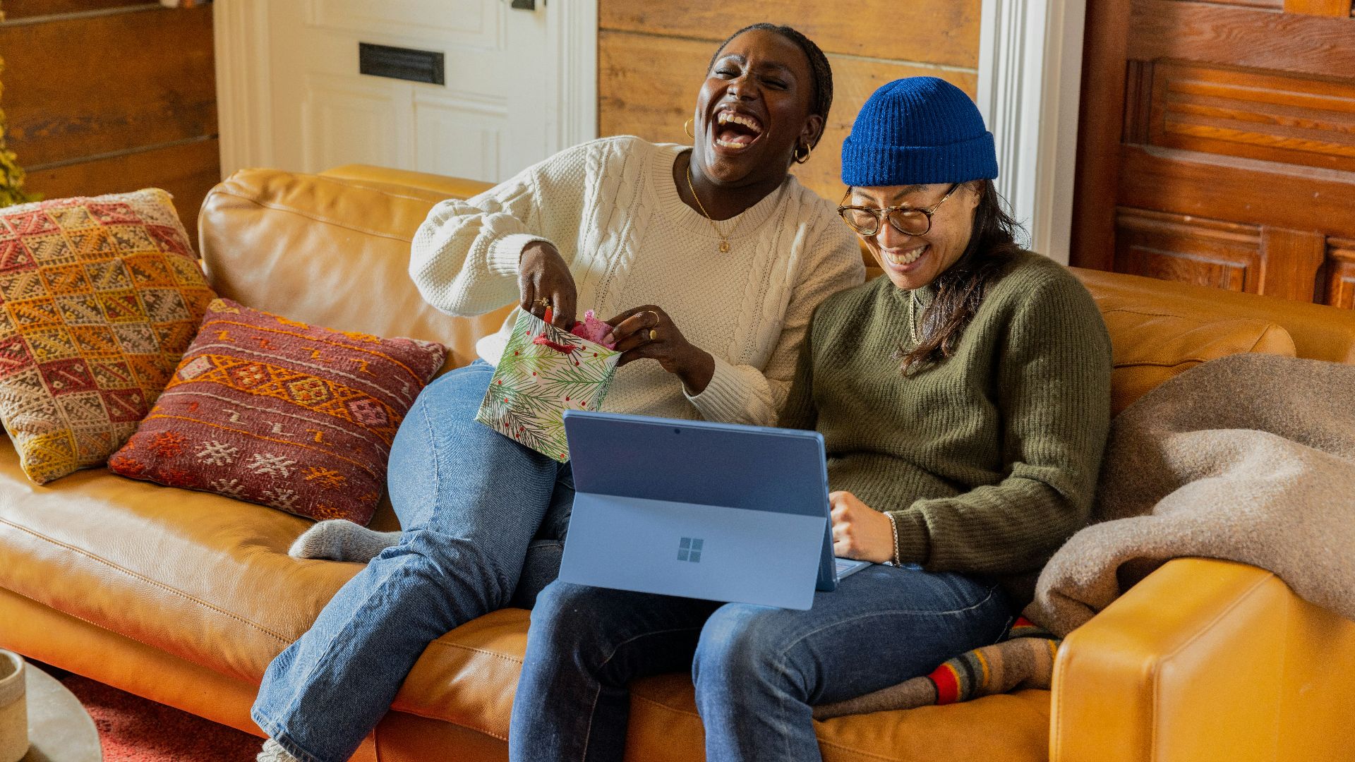 a person sitting on a couch with a laptop