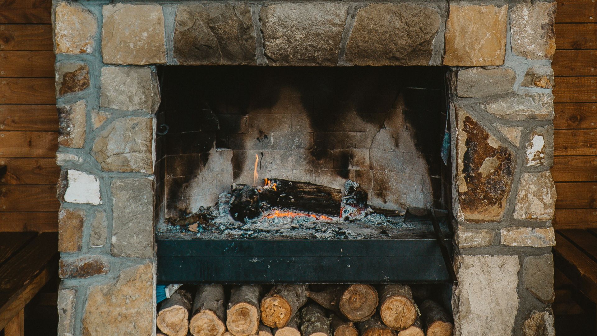 brown brick fireplace with bottles on top