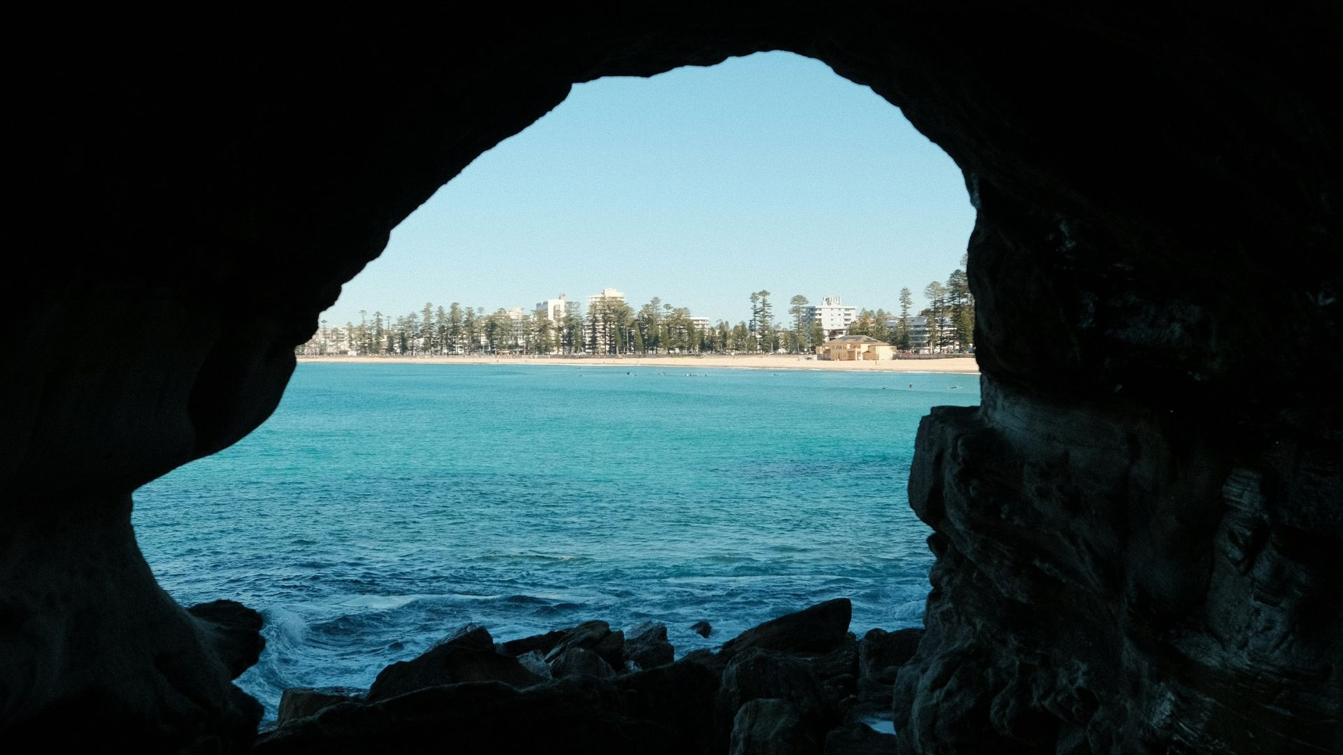 A view of a body of water through a cave