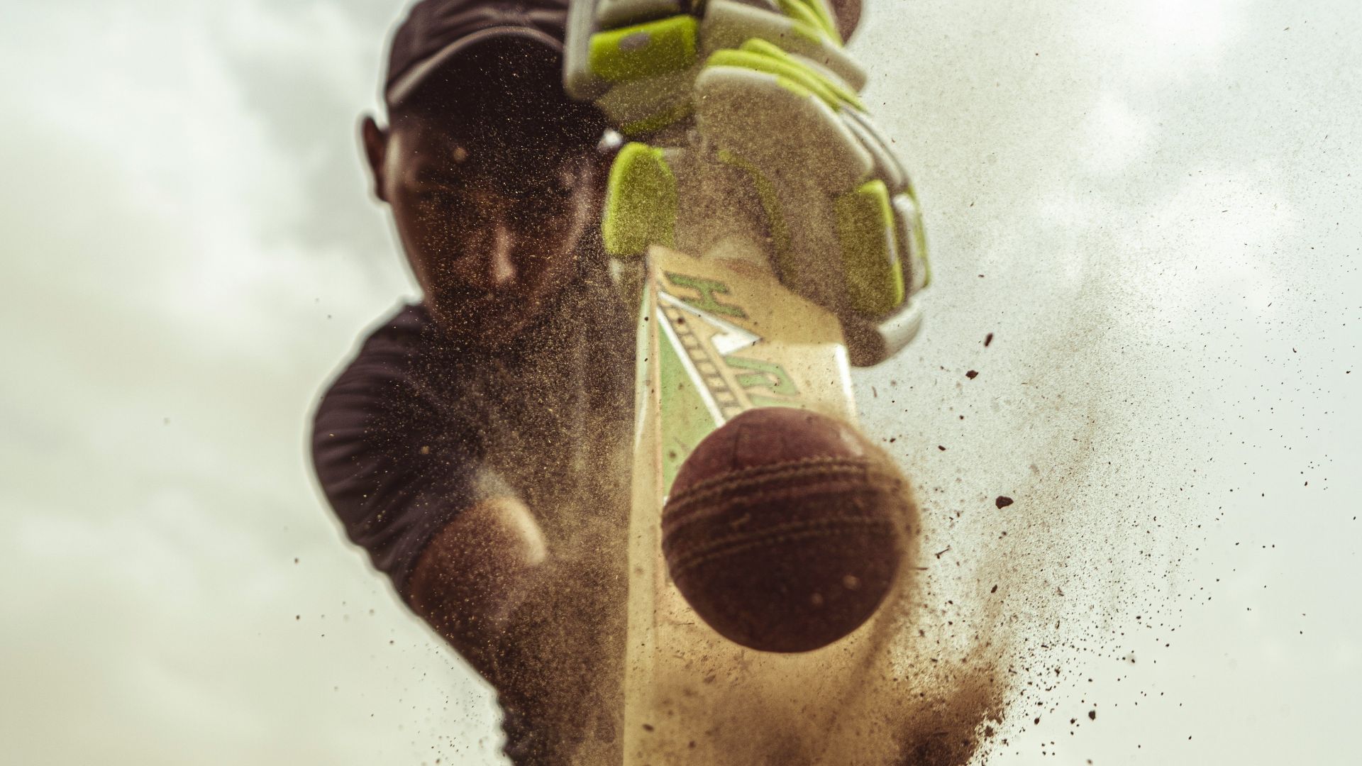 man in black jacket holding yellow and green plastic bottle