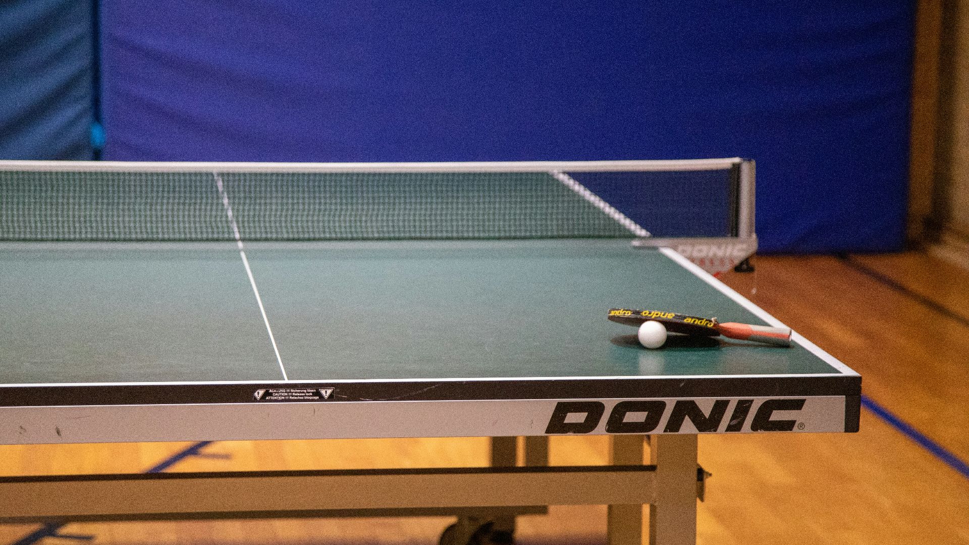 a ping pong table with a racket and ball on it