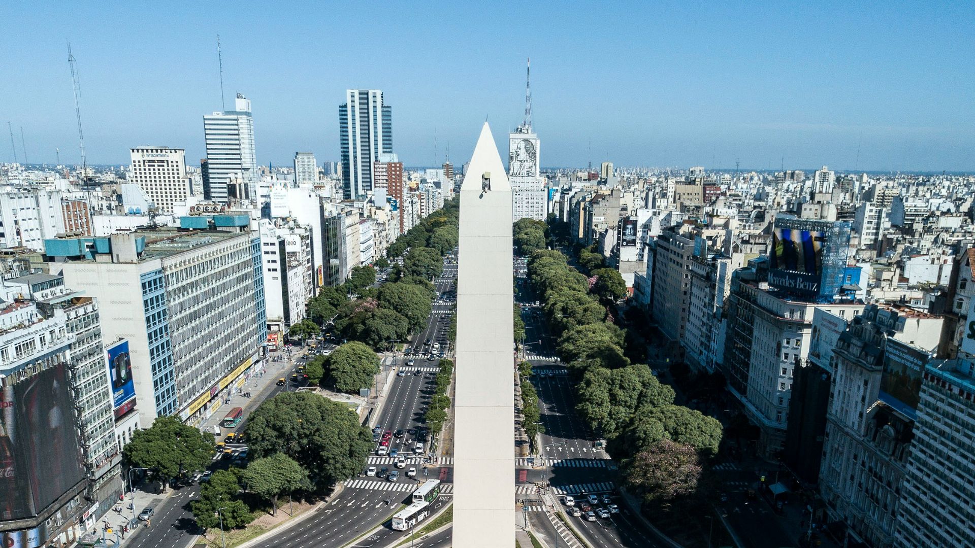 cars on road near city buildings during daytime