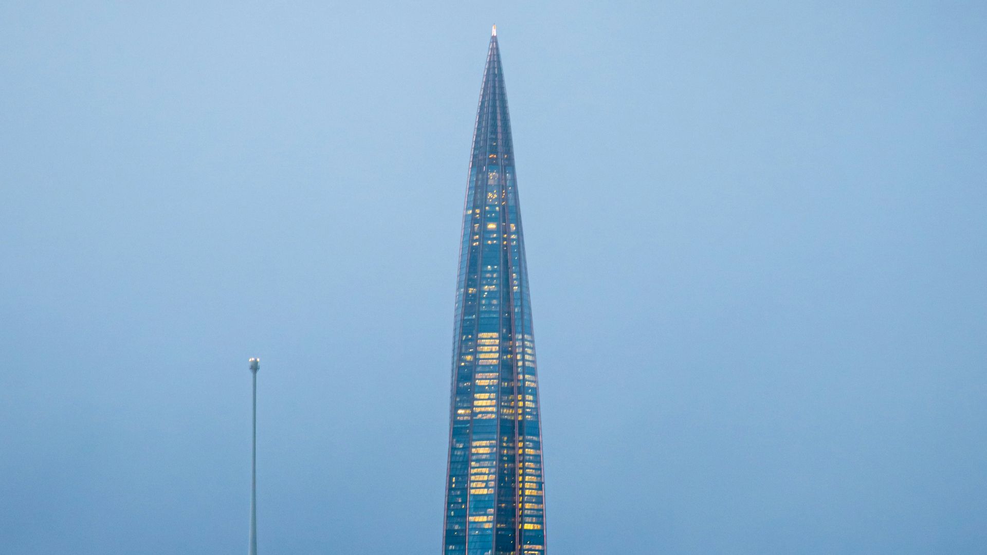 a very tall building sitting in the middle of a body of water