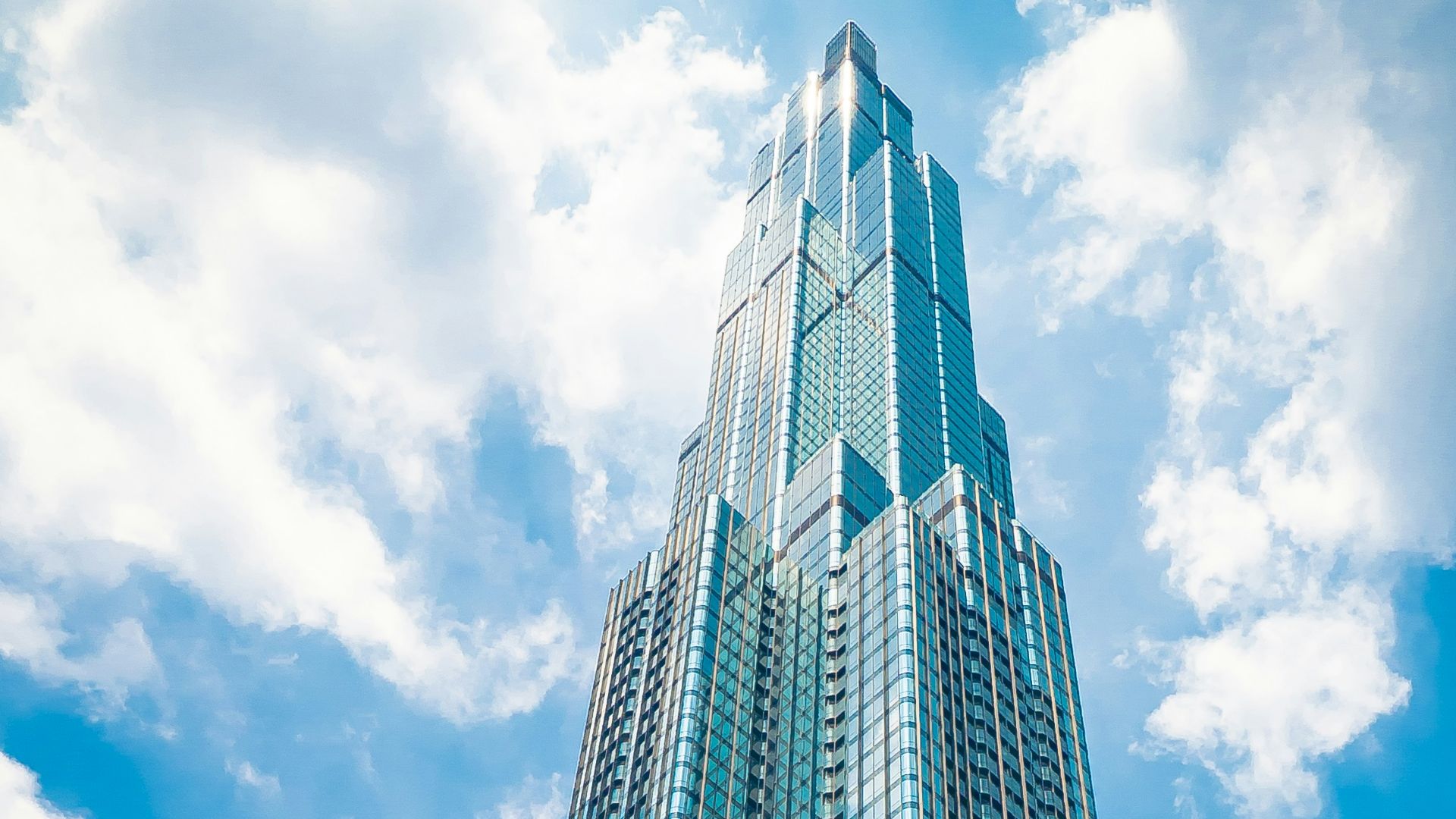 low angle photography of high rise building under blue sky during daytime