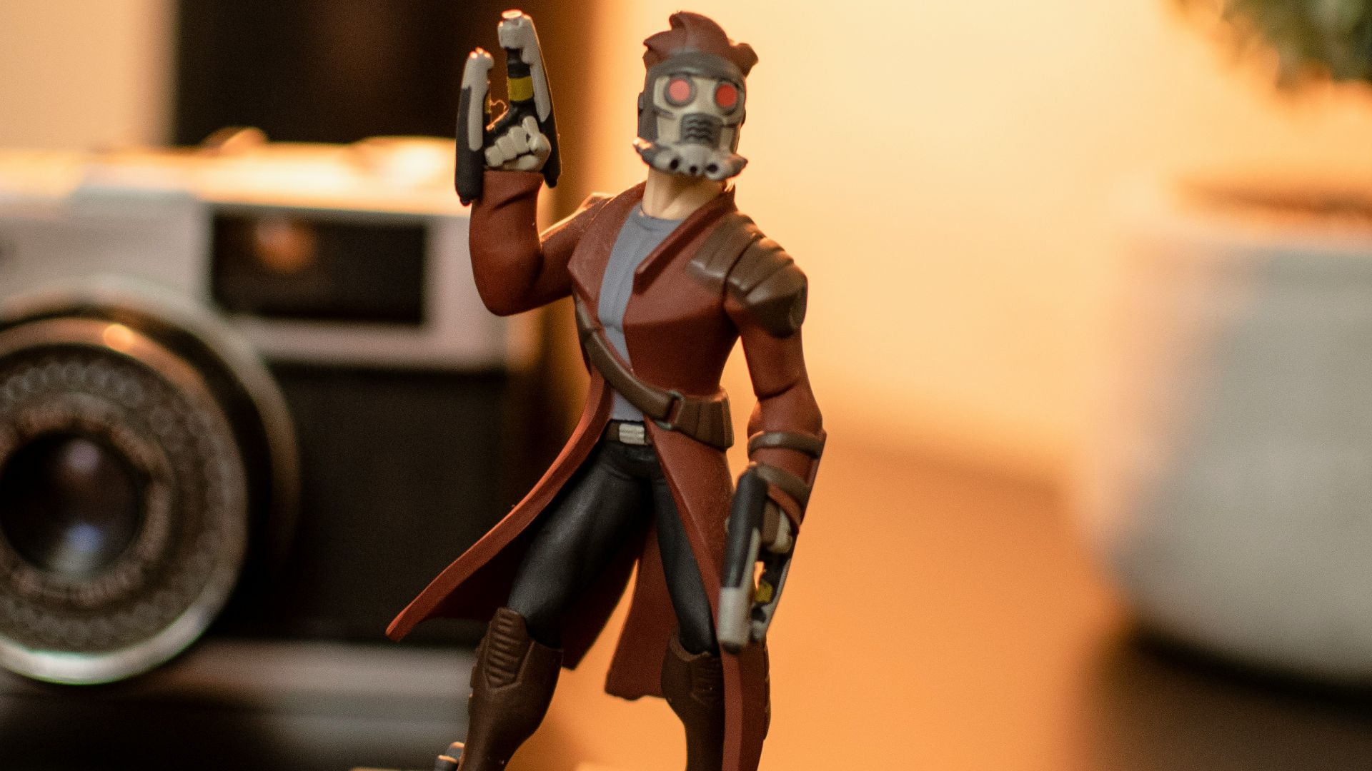 a figurine of a man with a camera in the background