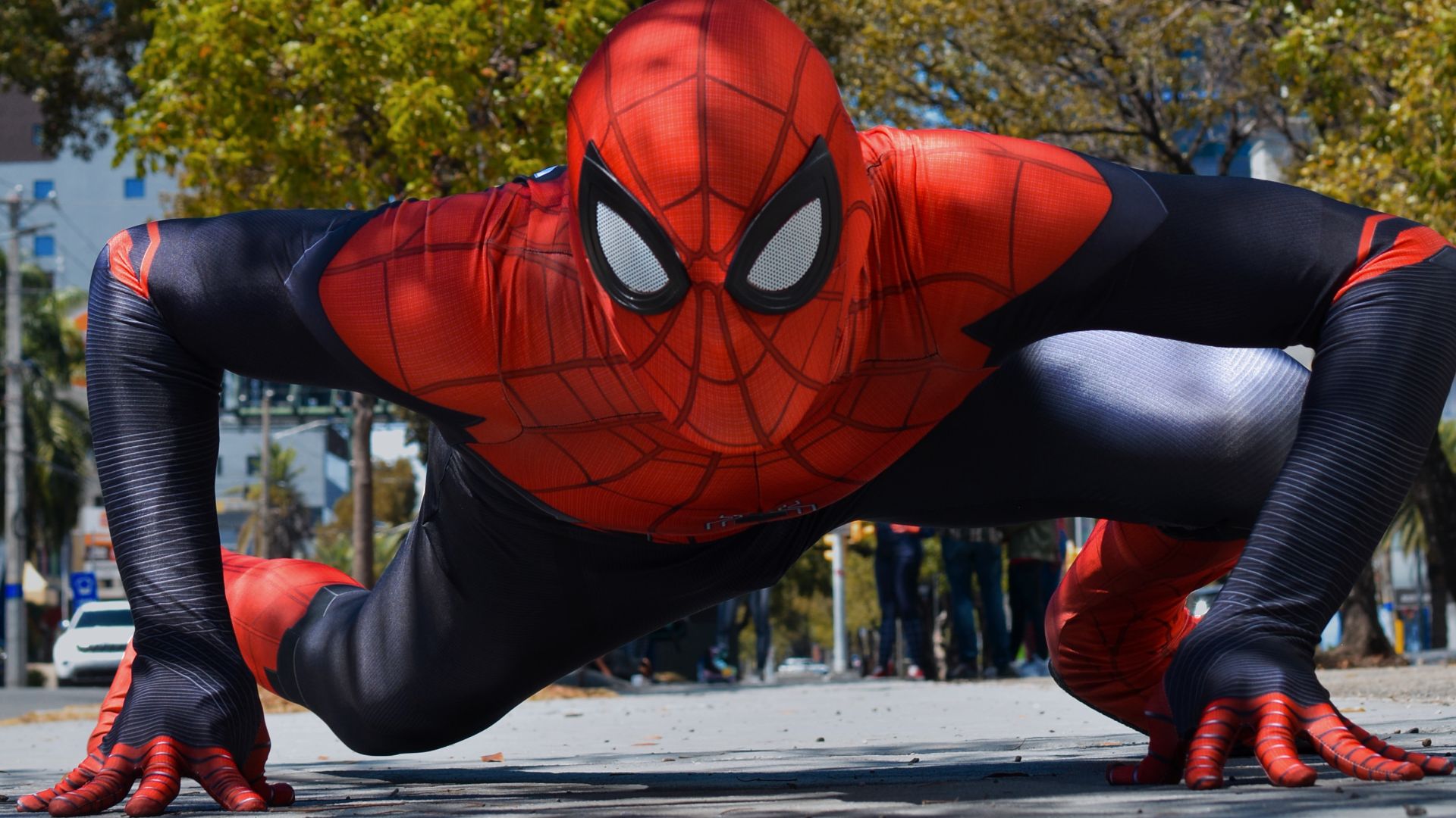 a man in a spider suit is doing a push up
