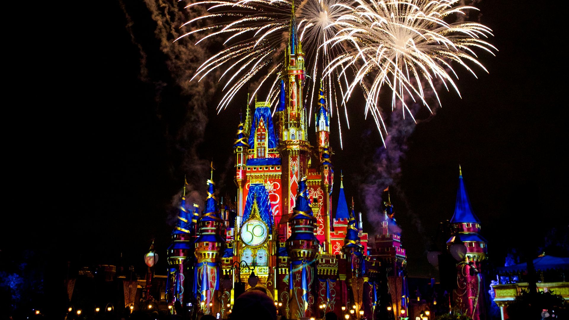 a castle is lit up with fireworks at night
