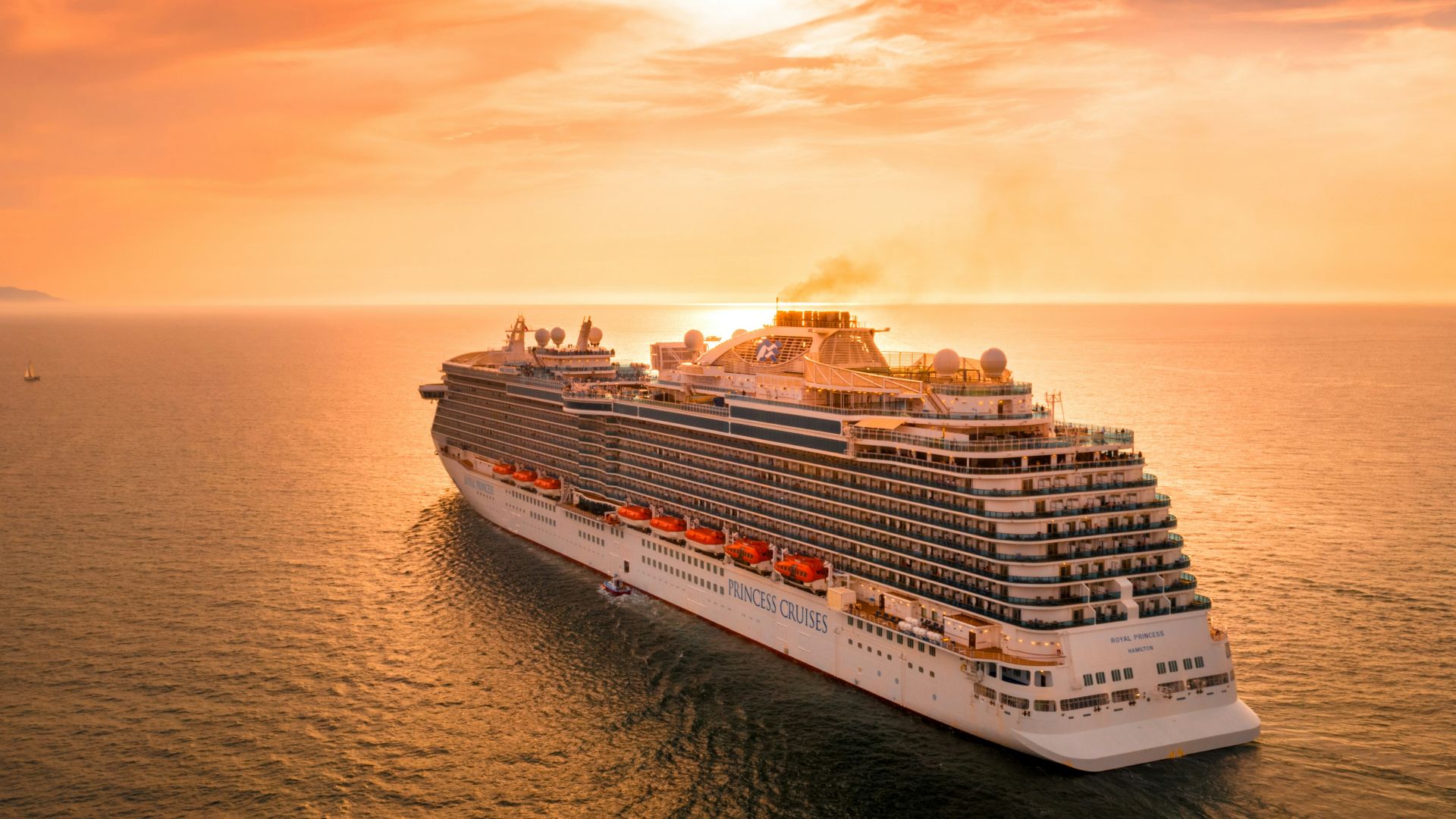 white ship on sea during sunset