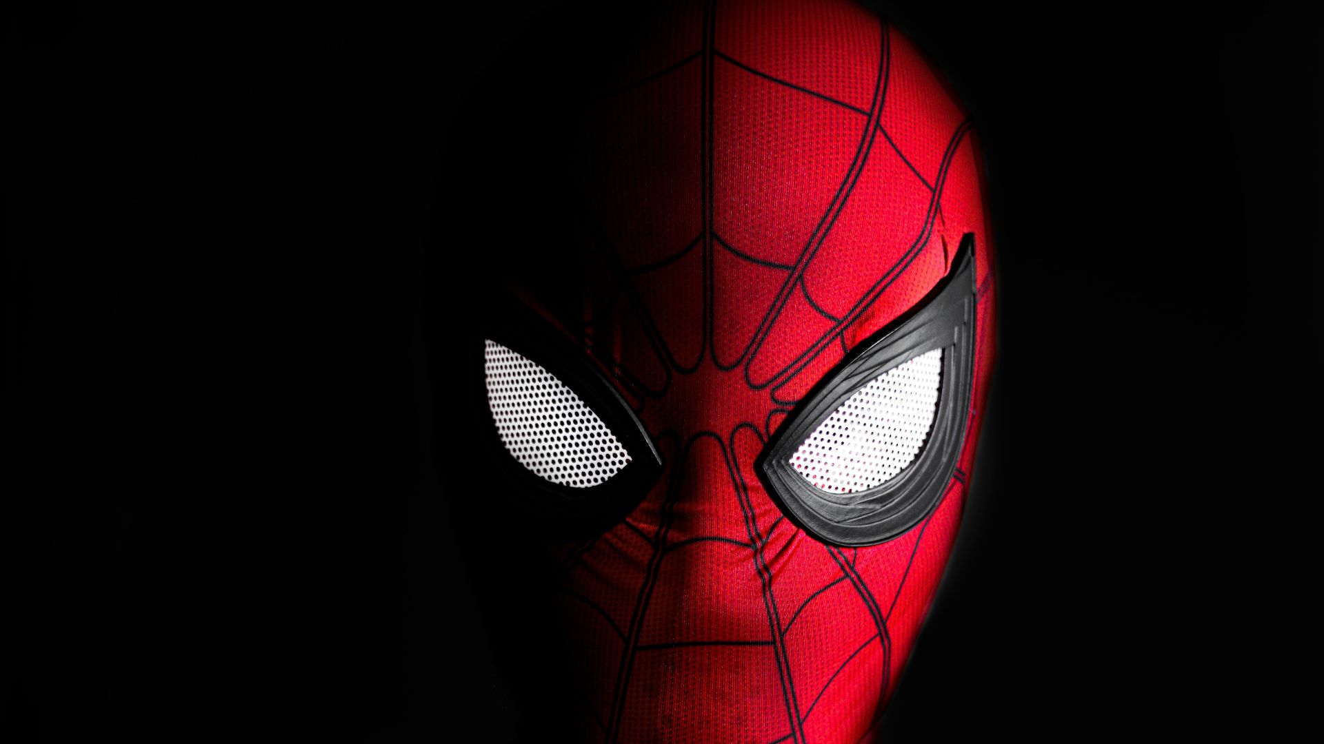 a close up of a spider man with glowing eyes
